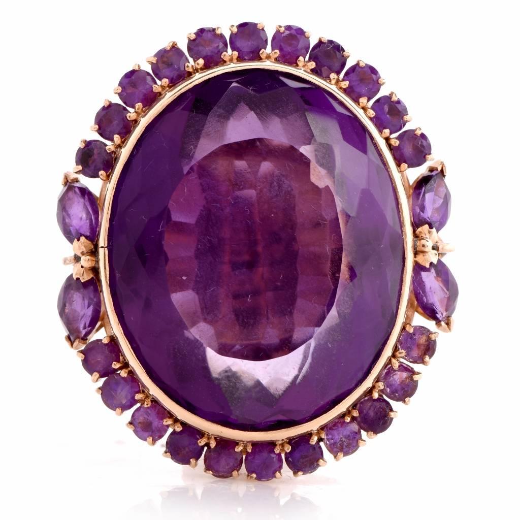 This Retro cocktail cluster ring is handcrafted in  18k yellow gold ring, it center with an  outstanding 48.00 ct  oval-cut checkerboard-faceted amethyst and  Surrounded  with four identical marquise  and 24 round-faceted amethysts approx. 3.65 its,