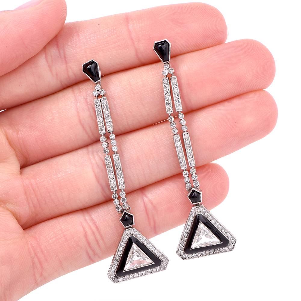 Chic geometric earrings  are crafted in solid platinum, weighing 9.3 grams and measuring 60mm long and maximum 17mm wide. The earrings incorporate a pair of color-contrasting triangular profiles centered each with a prominent triangular-cut diamond,