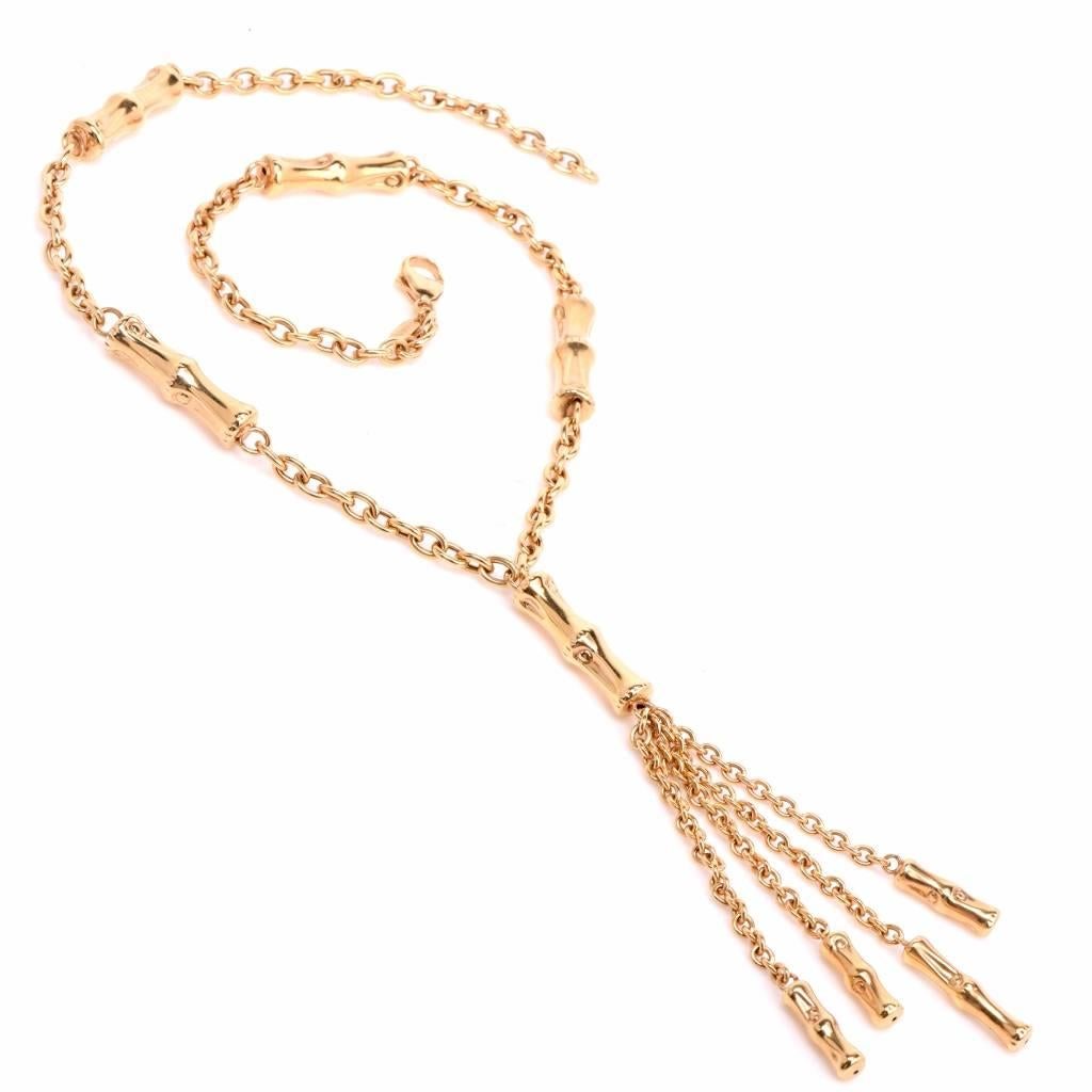 Artfully designed as a long chain necklace with five bamboo motif profiles and a delicate cascading tassel, this alluring Italian necklace signed 'IL Gioeiello' is crafted in high polished 18K yellow gold, weighing 32 grams and measuring approx.