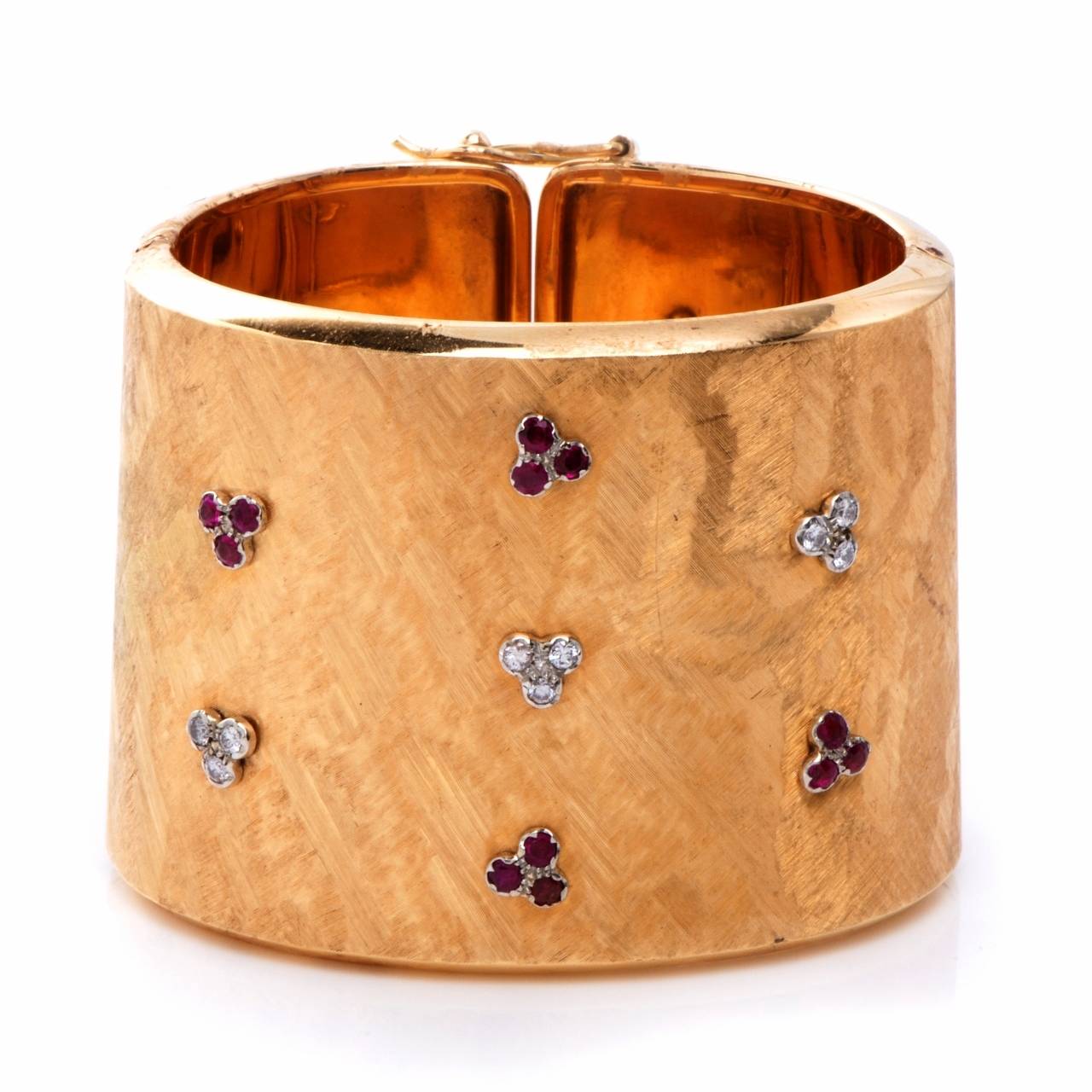 This immaculately designed wide cuff bracelet  rendered in a distinct wave-pattern textured solid 18K yellow gold weighs 105.3 grams and is approx 1.90