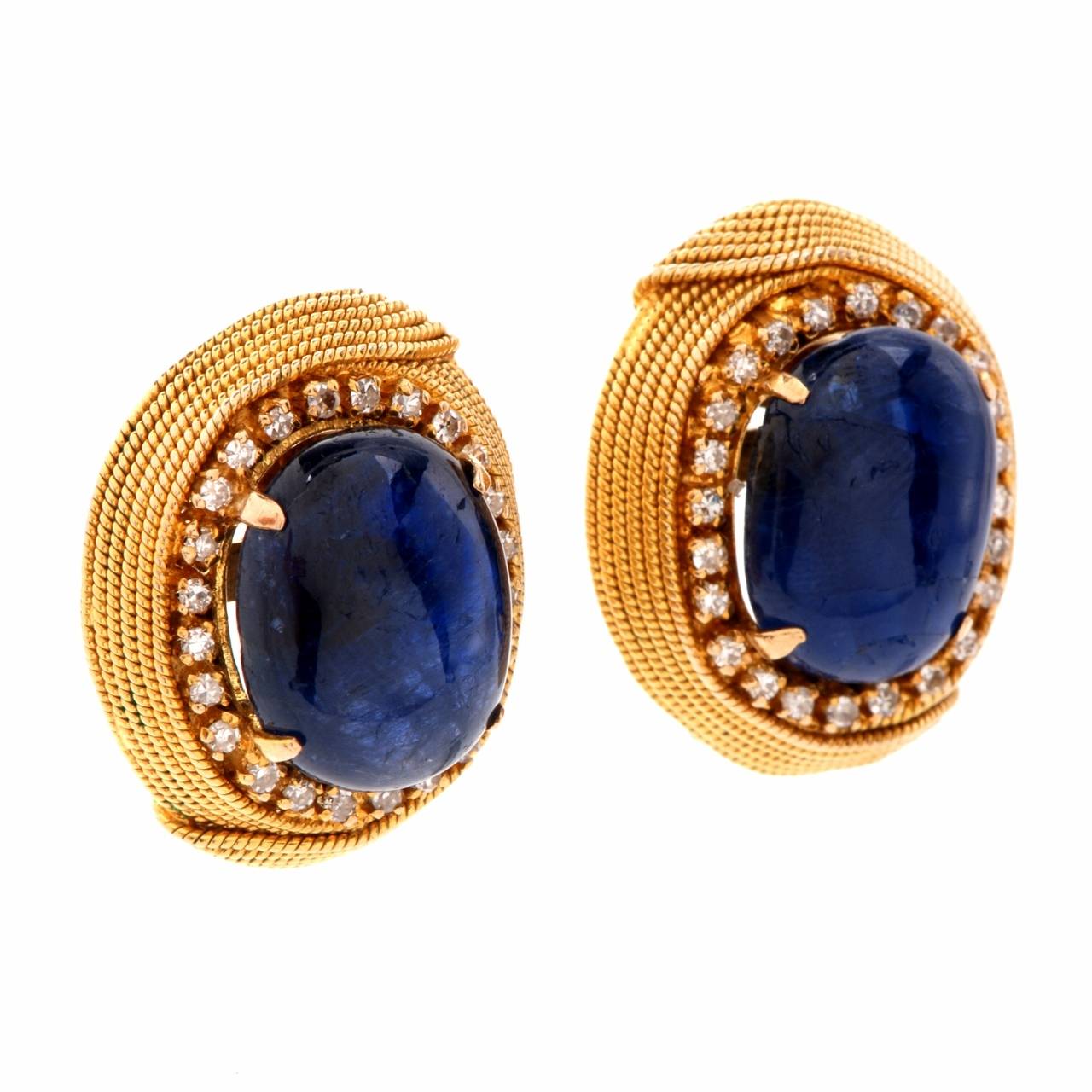 These estate Retro earrings of classic distinction and aesthetic beauty are crafted in solid 18K yellow gold, weigh 19.00 grams and measure 23 mm x 18 mm.  Designed as  artfully crafted oval plaques, these captivating earrings expose a pair of