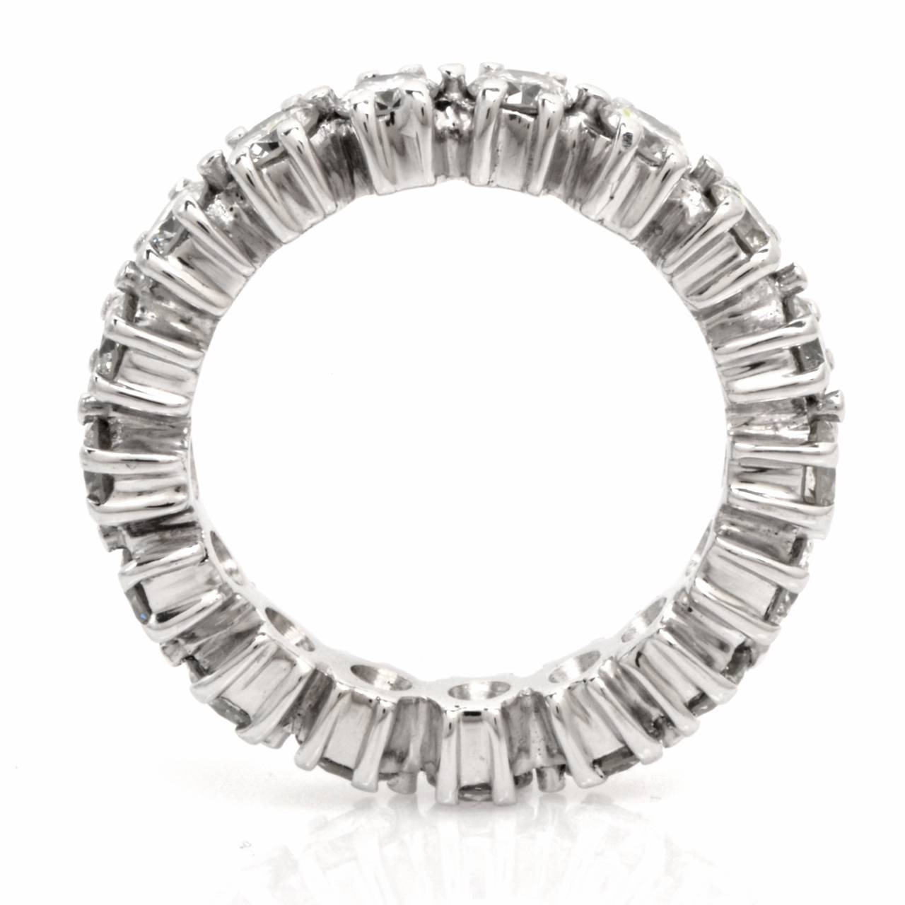 This alluringly feminine, stunning estate eternity band  of unmatched  sparkle and classically elegant aesthetic is crafted in solid platinum and weighs approx. 8.00 grams. This sophisticated  eternity band features 20 genuine prong-set 
