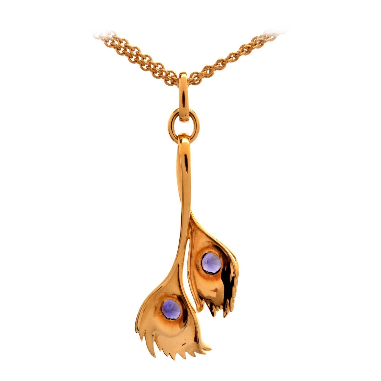 This lovely Carrera y Carrera peacock pendant necklace is crafted in solid 18K yellow gold. This pendant features a lovely peacock feather design with 2 genuine bezel set round tanzanites, approx 1.00cttw. This pendant also features an 18K dual