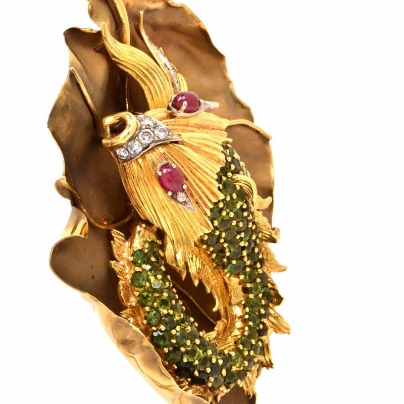 This fish  pendant is handcrafted in solid 18K yellow gold.  The large well-crafted designer pendant is showcasing a detailed fish design resting on top of a waterlilly leaf. It is covered with some 14 genuine round cut diamonds approx: 1.65 cts,