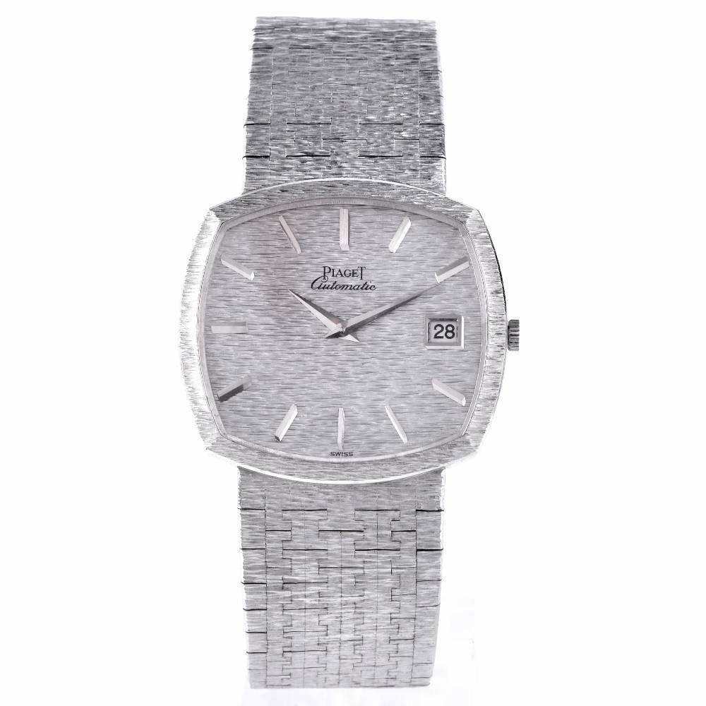 An 18k White Gold Cushion Case Gents Dress automatic Piaget Wristwatch, 18k White gold textured dial with fixed 18k white gold bezel and 18k white gold textured integrated full length bracelet gold clasp. All original parts with sapphire crystal,