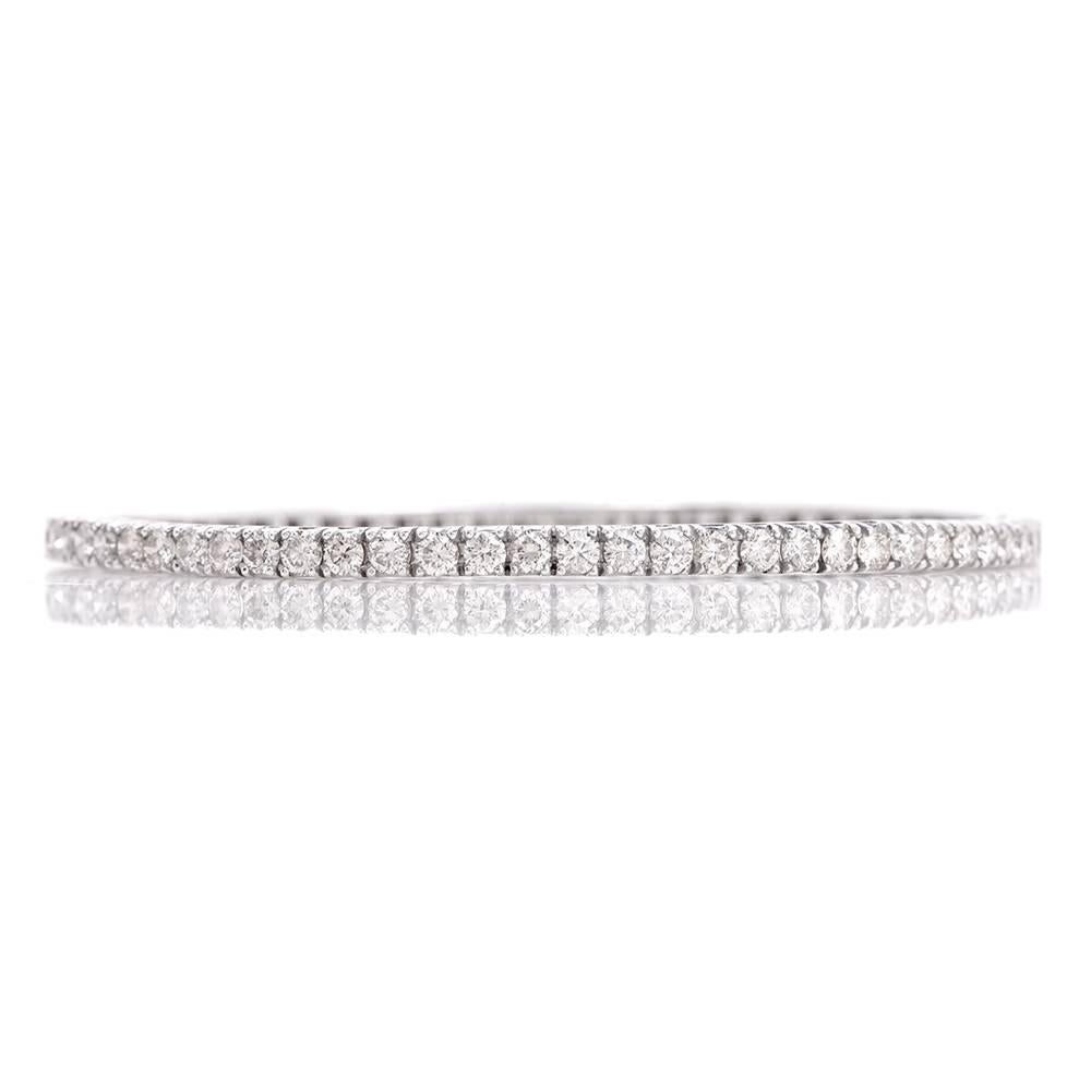 This estate bangle bracelet with diamonds is crafted in 18k white sold,  weighs approx. 15.7.00 grams and measures 7″ around the wrist. This refined line diamond bracelet of alluring feminine aesthetic is adorned with approx 70 round diamonds approx
