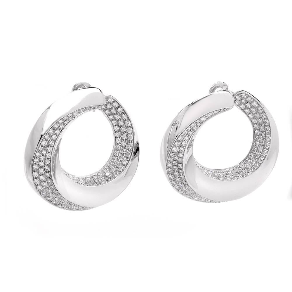 These stunning Designer Chopard hoop earrings are crafted in solid 18K white gold. They are set with approx: 300 genuine round cut Diamonds approx. 18.12cttw, F-G color, VS1 clarity, prong set on the inner and outer part of the hoop for a continuous
