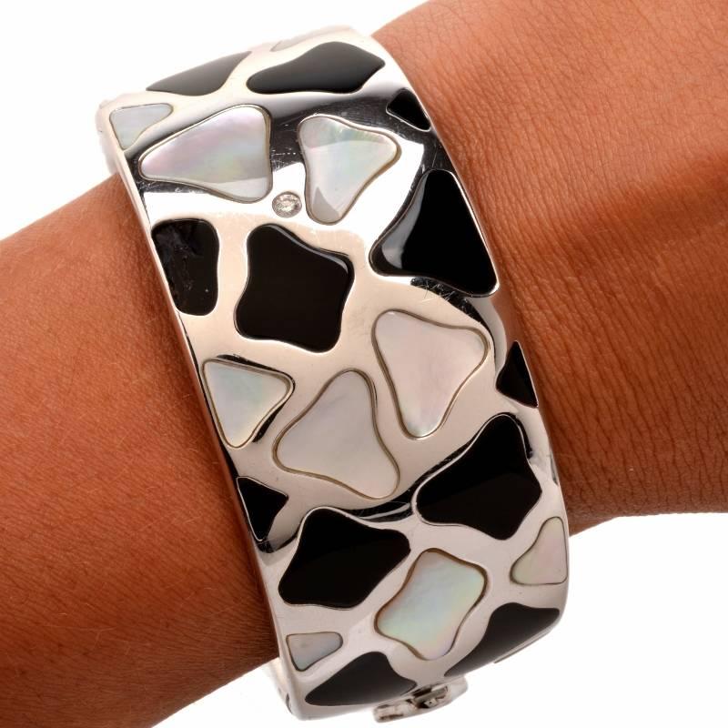 This gorgeous estate bracelet from Roberto Coin Panda collection is crafted in a combination of solid 18K white and yellow gold. This piece displays a creative assemblage of asymmetric profiles composed of carved black onyx and Mother of pearl,