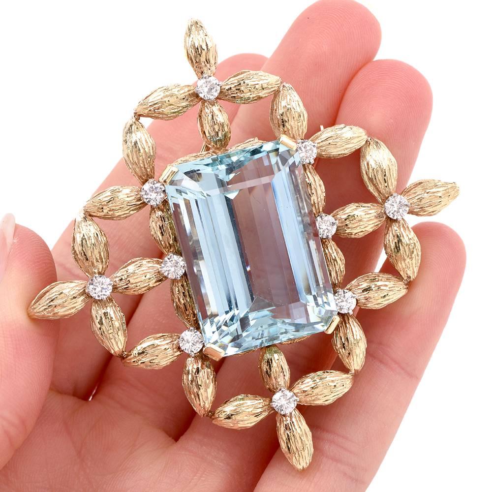 This vivacious estate 1960’s brooch and pendant with a prominent emerald-cut aquamarine and diamonds is crafted in solid 18K matted yellow gold . It is artfully textured in fine bark finish  pattern. This brooch incorporates a geometric diamond