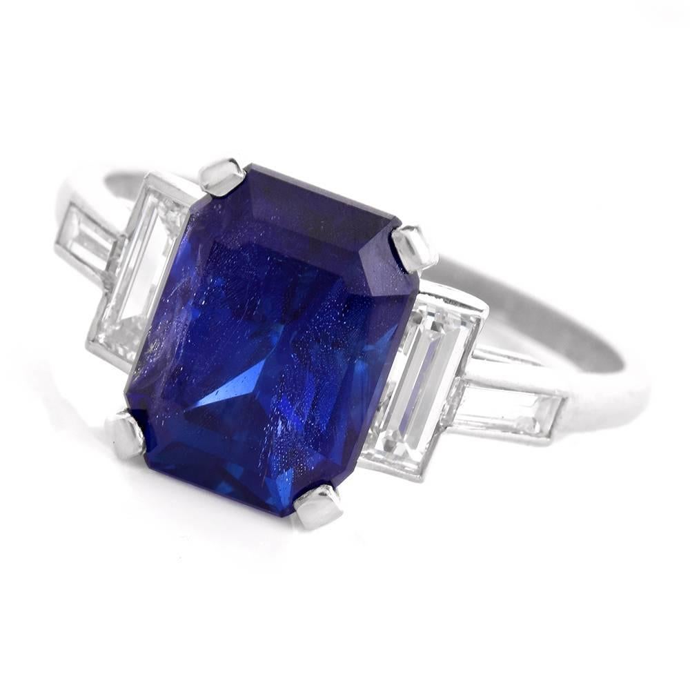 Showcasing this spectacular rare Burma emerald cut natural corundum blue Sapphire with no heat, AGL prestige report Documents # CS 1078604. This Burma sapphire with intense royal blue color weighing  approx: 5.07 cttw, prong set adorned on the sides