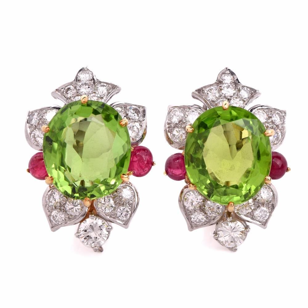 These exquisite chandelier earrings of vivacious aesthetic with prominent peridot gems*, ruby cabochons and diamonds are inspired by the 19th century Iberian Girandole style of earrings, crafted in solid 18k white gold and a touch of yellow gold