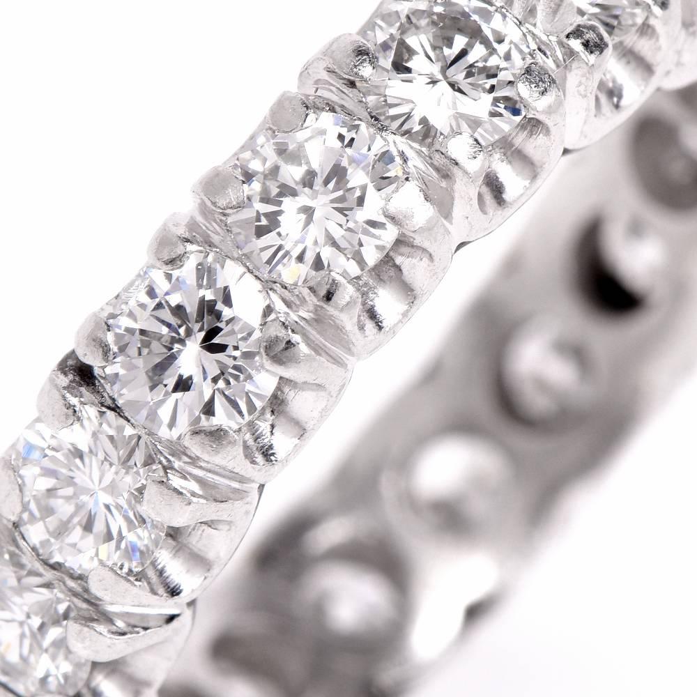 This classic estate eternity band of outstanding sparkle is crafted in solid platinum, addorned by 20 genuine prong-set round brilliant-cut diamonds approx. cumulatively weighing 3.10 carats, graded G-H color, VS1-VS2 In exceletnt condition.

Ring