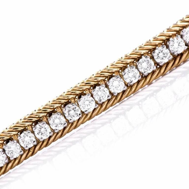 This alluring Hammerman Brothers bracelet Circa 1980's is crafted in solid 18K yellow gold with platinum applied to the entire setting of diamonds. Designed as a refined line bracelet, is adorned with 77 round diamonds approx 3.85cts, graded F-G