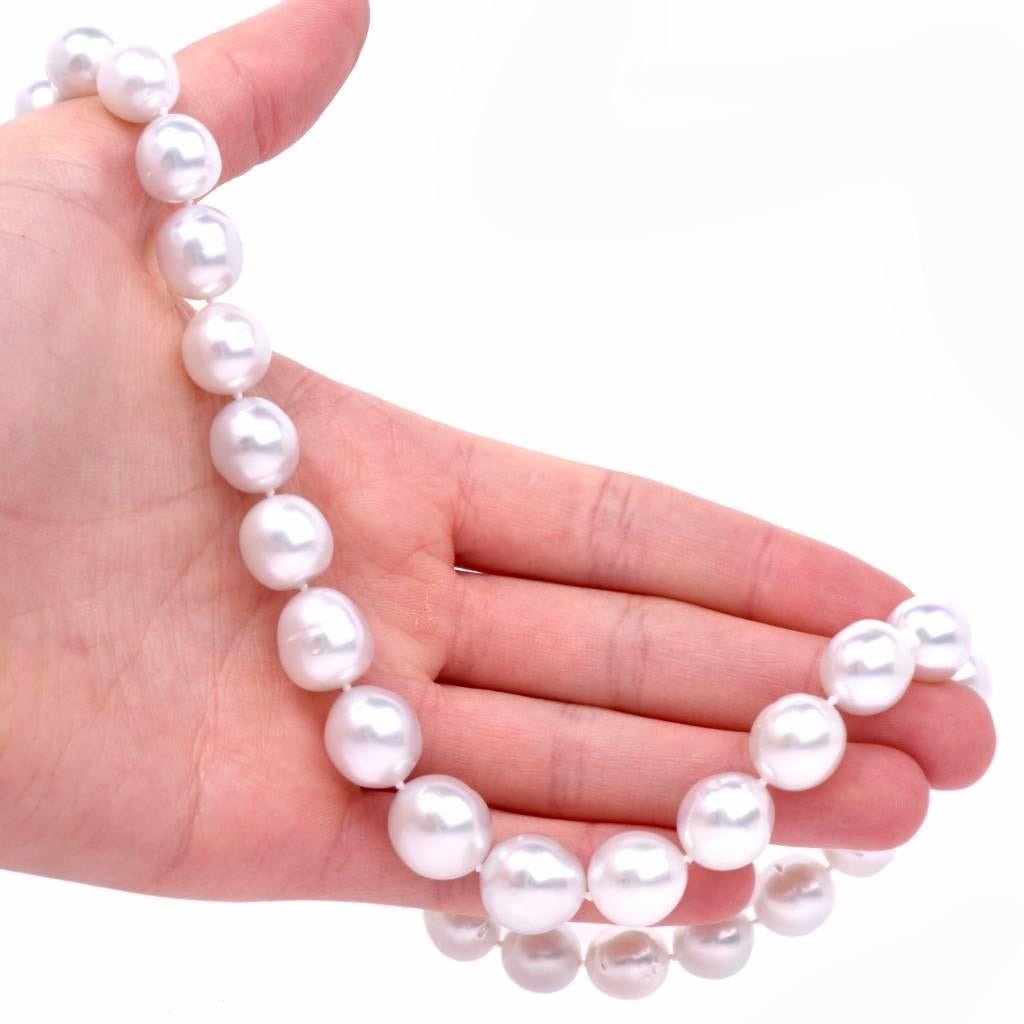 This classically distinct South Sea Pearl necklace incorporates 33 highly lustrous South Sea pearls with some natural blemishes. The necklace is complemented by 33 graduated lustrous South Sea pearls measuring between 13mm to 11 mm. The necklace
