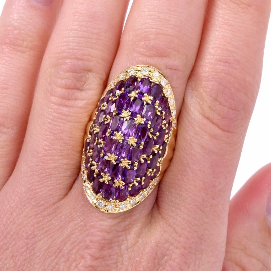 1980's cocktail ring gracefully made in solid 18-carat gold and topped  with some 42 oval faceted amethysts approx 21.50 carats mounted in 6 adjacent rows and intersected by Etruscan Revival inspired gold bead profiles. The alluring purple stones