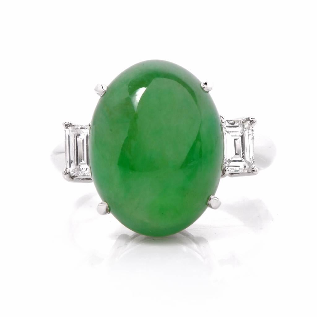 This stunning three stone ring featuring a 10.40 ct cabochon-cut genuine green jade with excellent condition a four claw setting between two high quality Baguette cut diamonds. The diamonds are estimated as F-G color and VVS clarity with a total