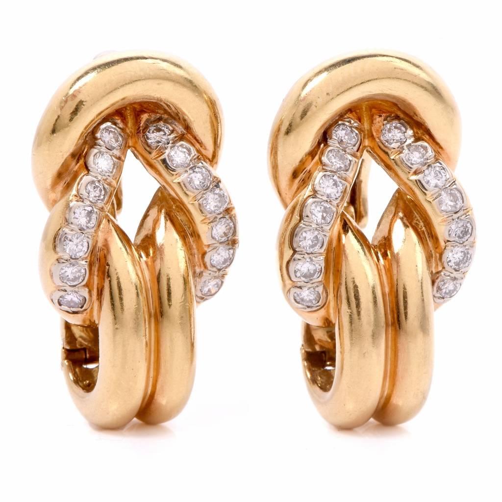 These Vintgae clip-back earrings of opulent and classically distinct aesthetic are crafted in 18-Karat yellow gold. The earrings depict at the center an openwork inverted heart profile, set  with 28 round-faceted diamonds in total. The precious