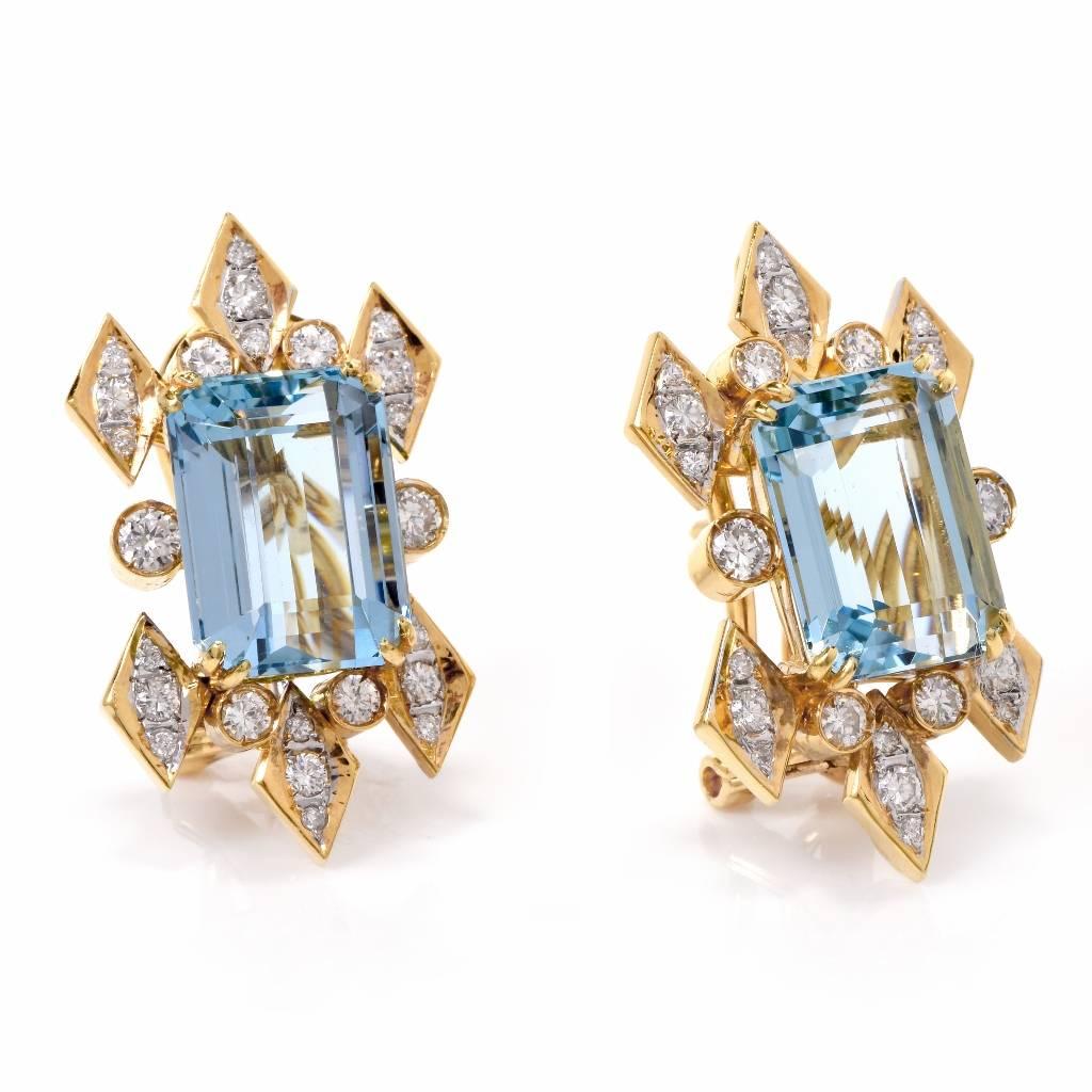 These captivating Art Deco inspired estate clip-back earrings crafted in solid 18 karat yellow gold expose a pair of translucent octagonal step-cut blue topaz gems weighing cumulatively 15.30 carats. Set within 4 paw prongs, the translucent azure