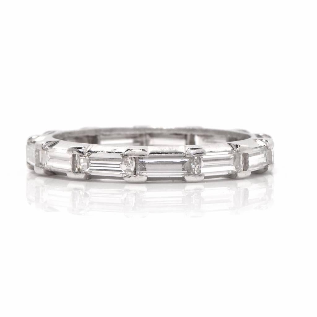 Showcasing this Diamond Baguette eternity band of unsurpassed refinement is crafted in platinum, channel-set with 13 straight baguette diamonds, cumulatively weighing 1.15 carats, graded F-G color and VS1-VS2 clarity.

This enchantingly delicate
