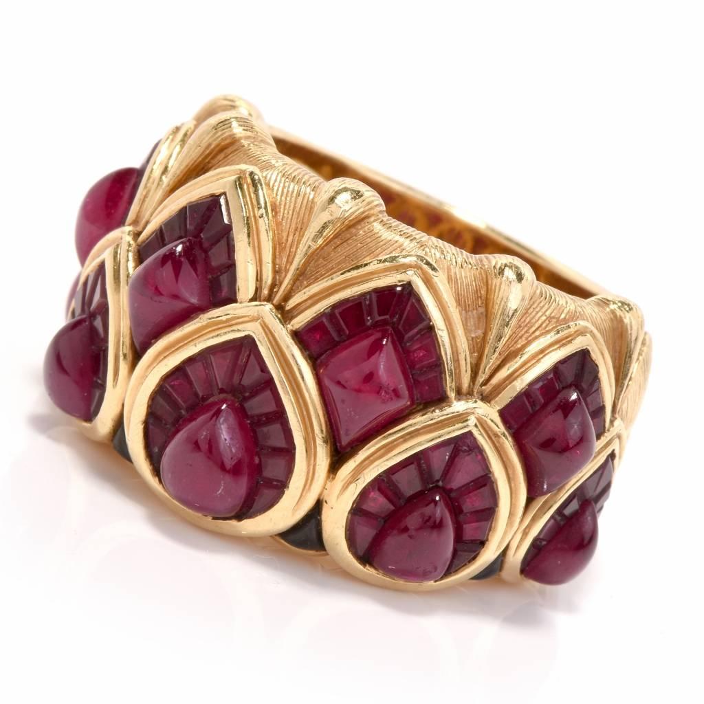 This elaborately detailed and immaculately handcrafted  cocktail ring with variously cut rubies is crafted in solid 18K yellow gold, weighs 21.6 grams and is 16 mm on top. This wide band ring is adorned with 5 teardrop shape and 4 diamond-shape ruby