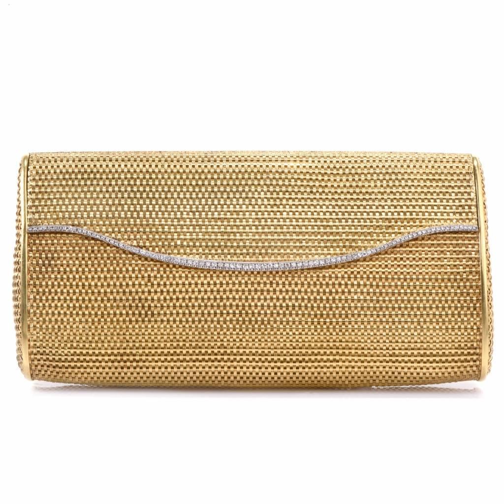 This classy handbag of sophisticated aesthetic is crafted in solid 18K yellow gold, rendered in absorbin g woven basket pattern mesh gold. It weighs 393.3 grams and measures over 7 inches long x 3.5 inches wide. The upper part is immaculately hinged