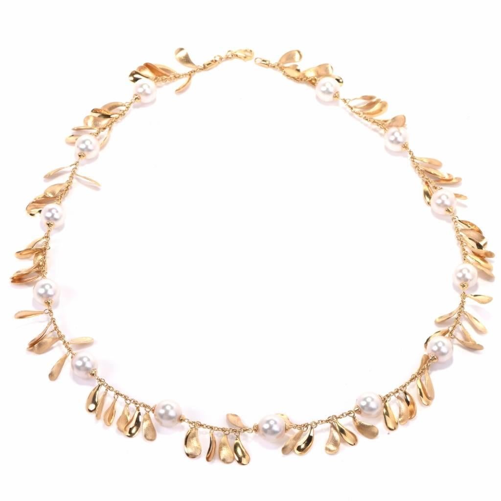 his gracefully feminine and elegant Italian  necklace is crafted in 14-karat yellow gold and exposes 13 lustrous pearls measuring 9mm in diameter, of a tender white with a pinkish hue color. The genuine organic gems are drilled and strung along a
