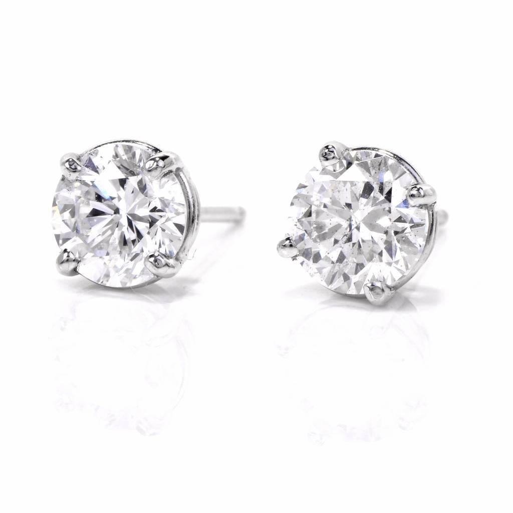 These classic platinum stud earrings from an estate are mounted with a pair of sparkling round brilliant-cut diamonds, cumulatively weighing 1.75 carats, H-I graded very nice SI clarity. The precious stones are mounted within timelessly elegant