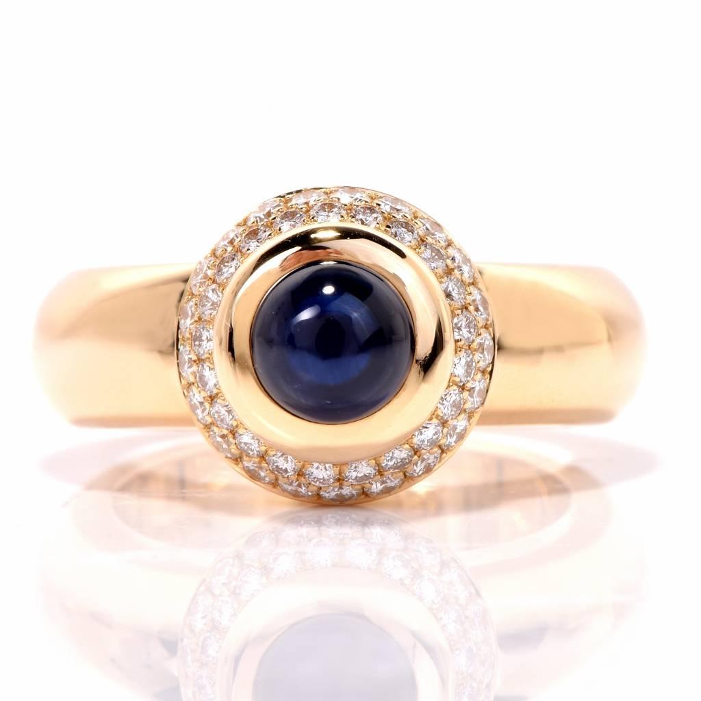 This lovely  Chopard ring from the designer's, 'Love Ring' collection is crafted in solid 18K yellow gold, weighing 17.1 grams and measuring 12mm in diameter and 10mm high. Designed as an alluring circular, subtly domed plaque, it is centered with
