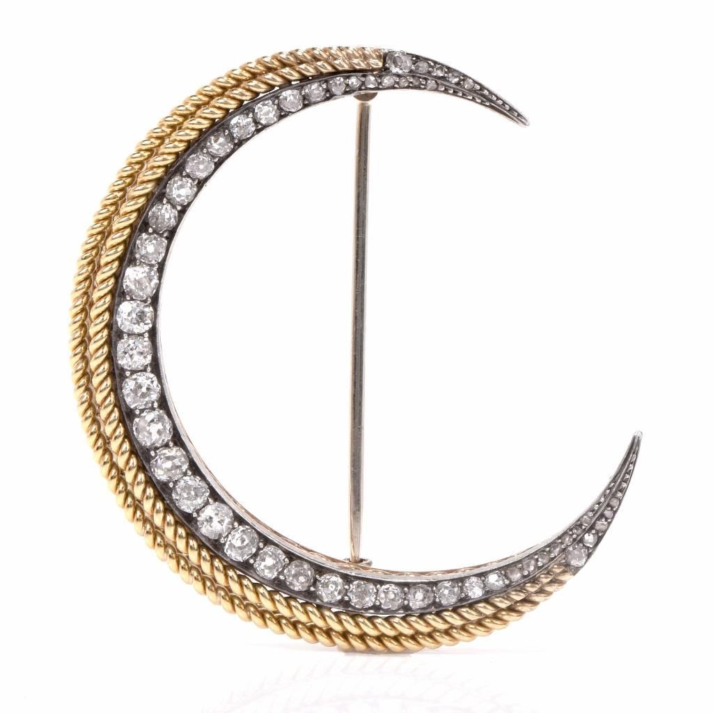 This antique pin brooch with diamonds is crafted in a combination of 18K yellow and white gold, weighing 13.9 grams and measuring 40 mm long x 47 mm wide. Designed as a delicate half-moon profile, the antique brooch is adorned with approx. 2.35