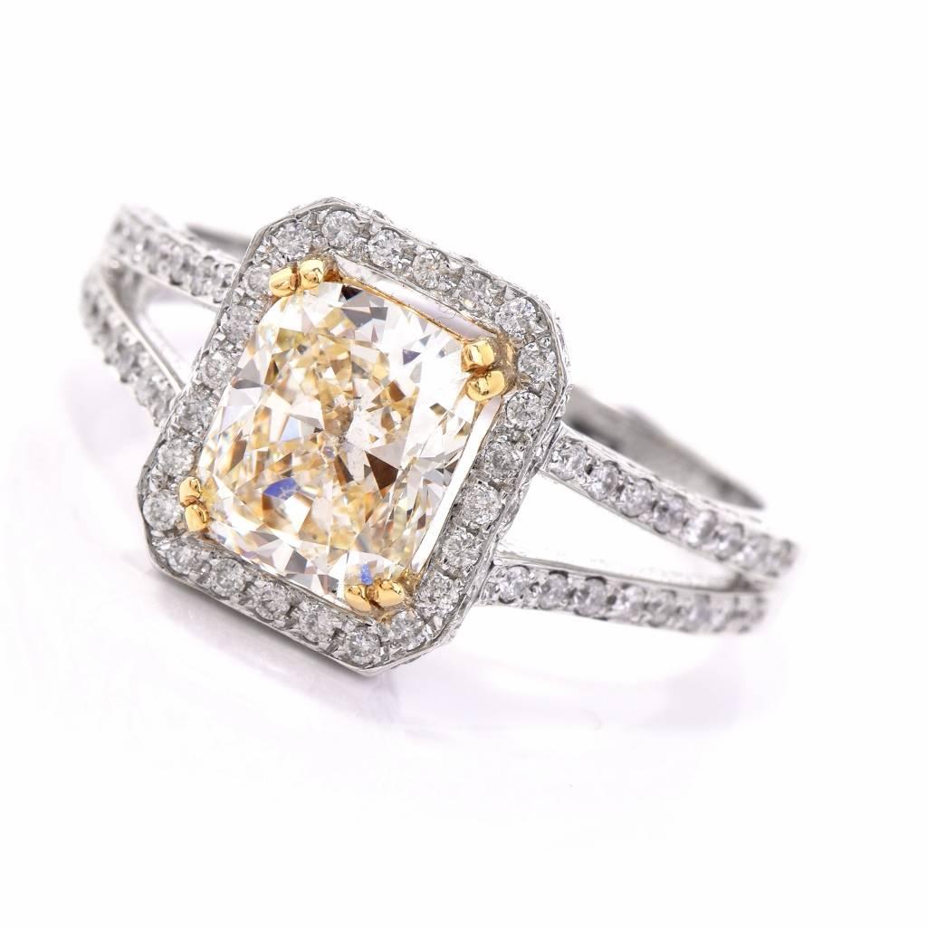 Crafted in solid 18-karat white gold, this stunning yellow diamond engagement ring exposes at the center approx. a 2.04 carat light yellow Radiant-cut diamond, very nice SI1 clarity. The eye-catching light yellow diamond is secured by prongs within