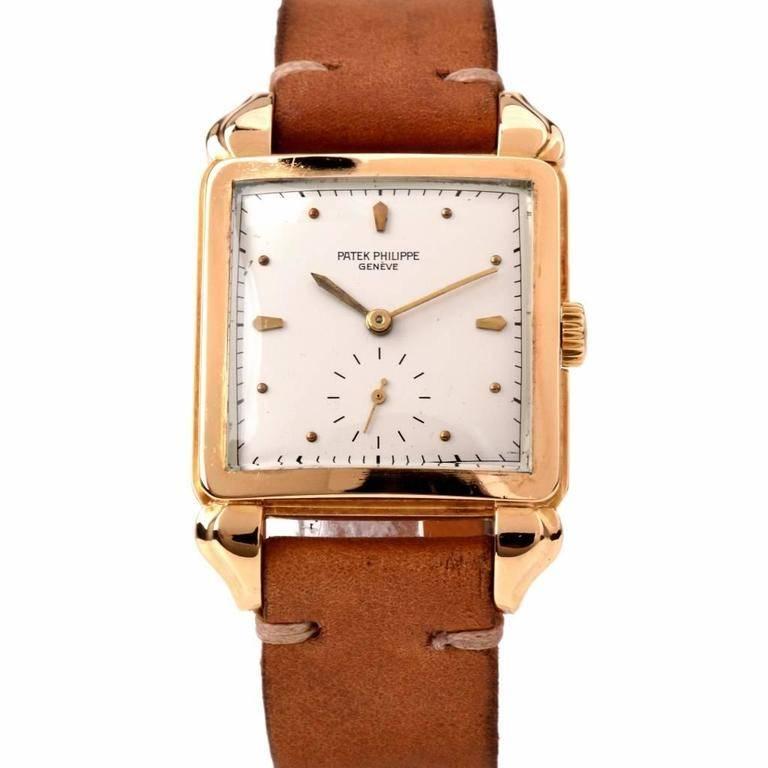 A vintage wristwatch, by Patek Philippe, circa 1950, refrence number 2424 in 18k yellow gold with square 30mm case from 1950s. Manual jeweled movement on a leather strap, sharp edges to the oversize flame teardrop lugs. The dial with applied tapered