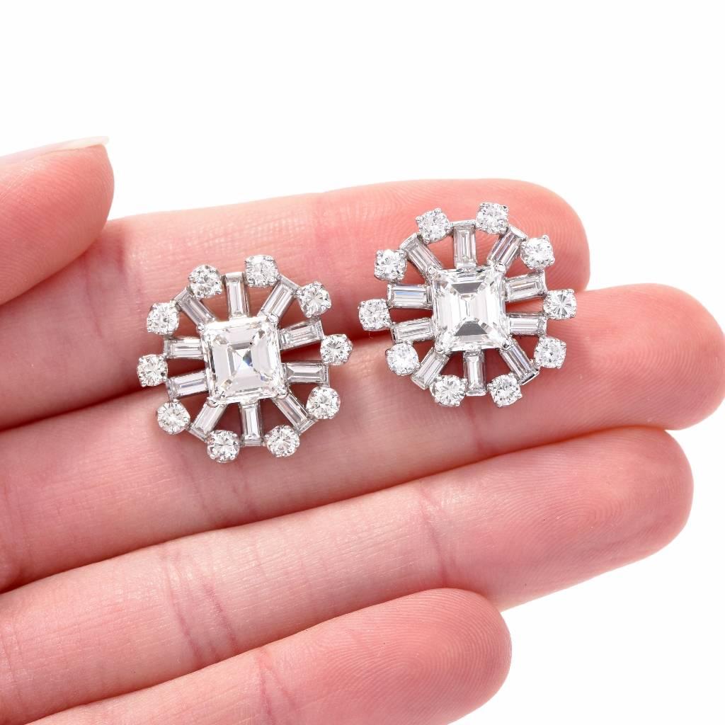 These impressive estate diamond stud cluster earrings are crafted in solid platinum, weighing approx. 13.8 grams, 20mm in diameter, designed as round plaques. These alluring sparkling stud earrings are centered with a pair of square-cut diamond
