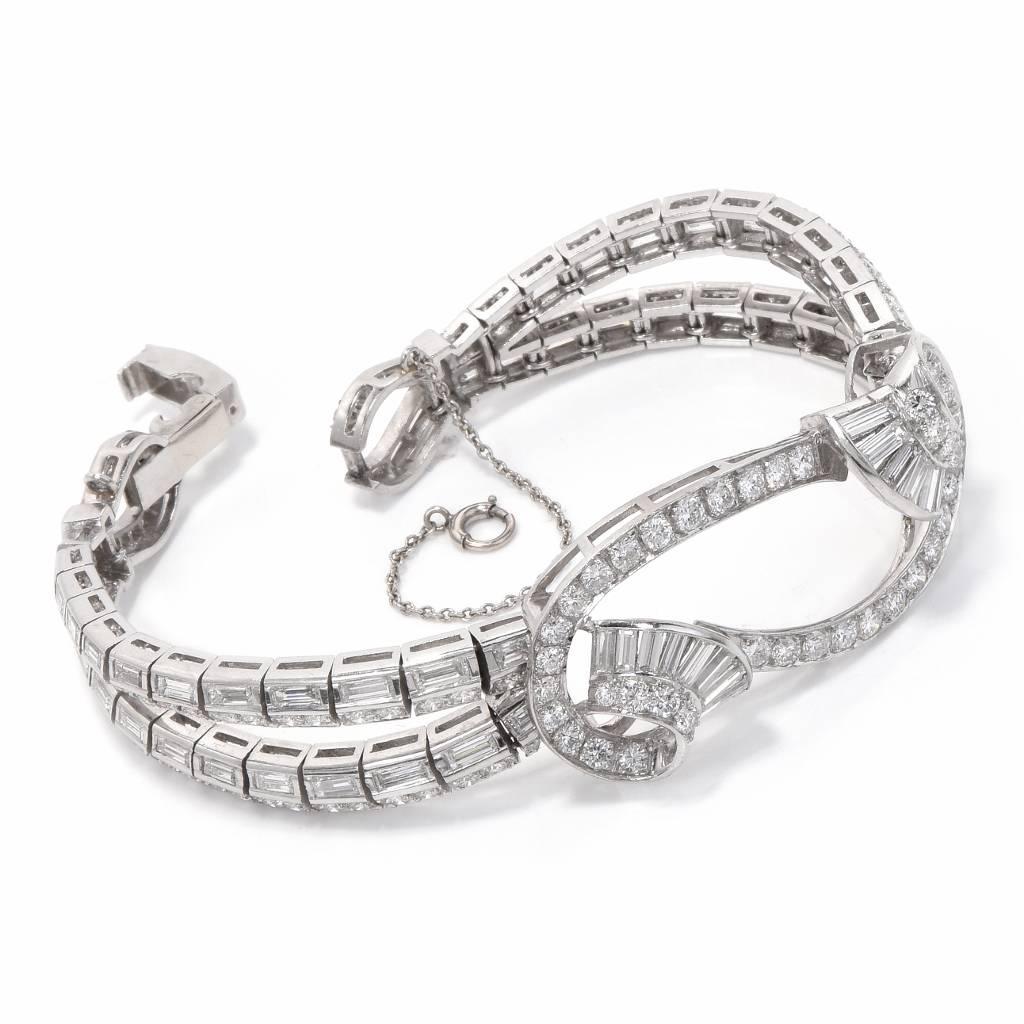 This spectacularly designed 1960's ladies bracelet is crafted in solid platinum, weighing 50.1 grams and measuring inches long. This finely make bracelet is centrally positioned with a free style shape open decor, set with round and Baguette