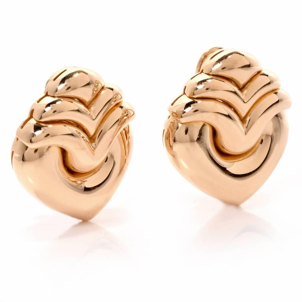 These elegant pair of authentic Bvlagar earrings are crafted in solid 18K yellow gold. These fabulous  earrings display a fancy double curved winged top with a heart underneith, finished with a bright polish for extra shine. They secure with Clip