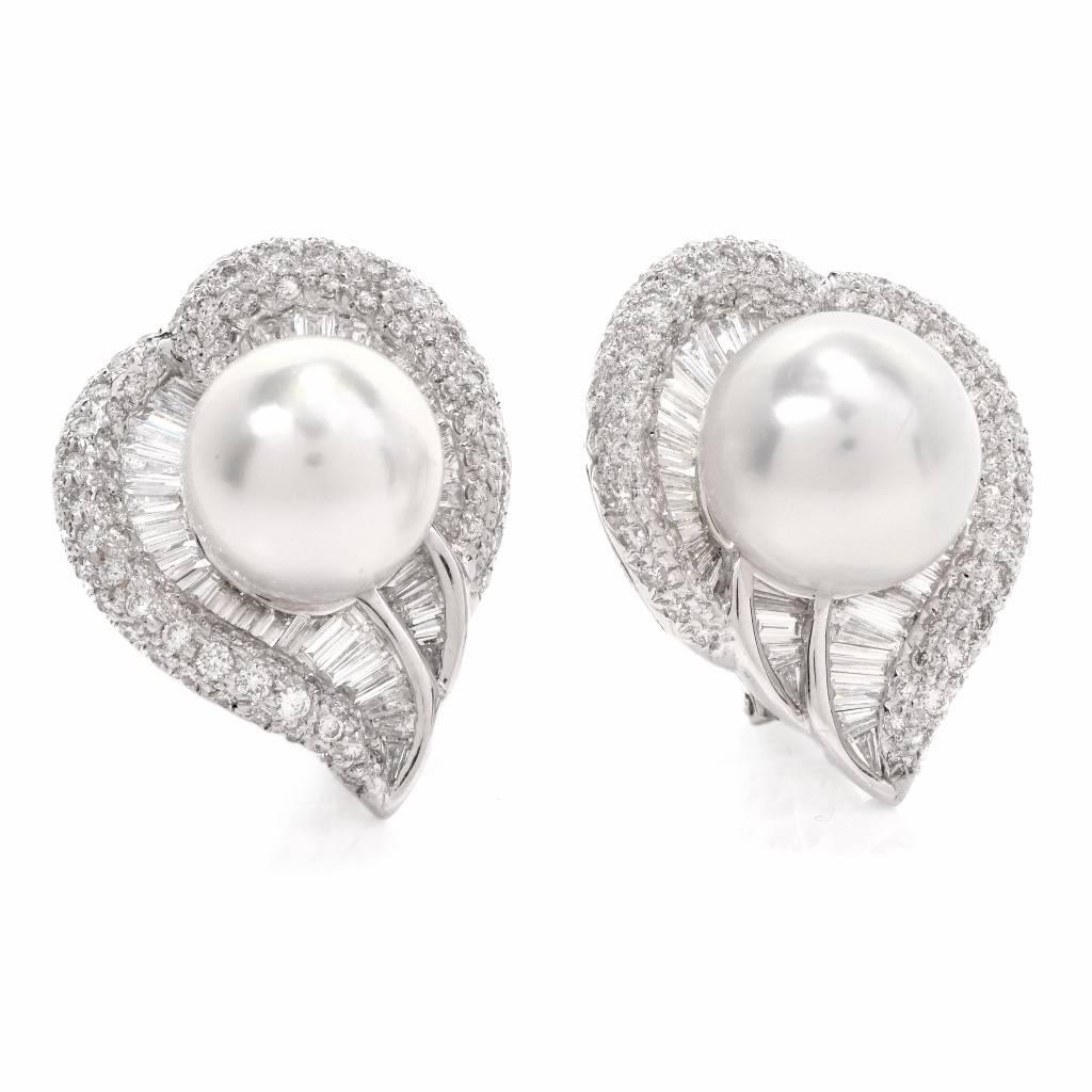 These elegant pair of South Sea Pearl & Diamond fancy heart cluster earrings are crafted in solid 18K white gold.

These ffashionable earrings displays a fancy heart shape design centered with 2 genuine South Sea Pearls with natural blemishes