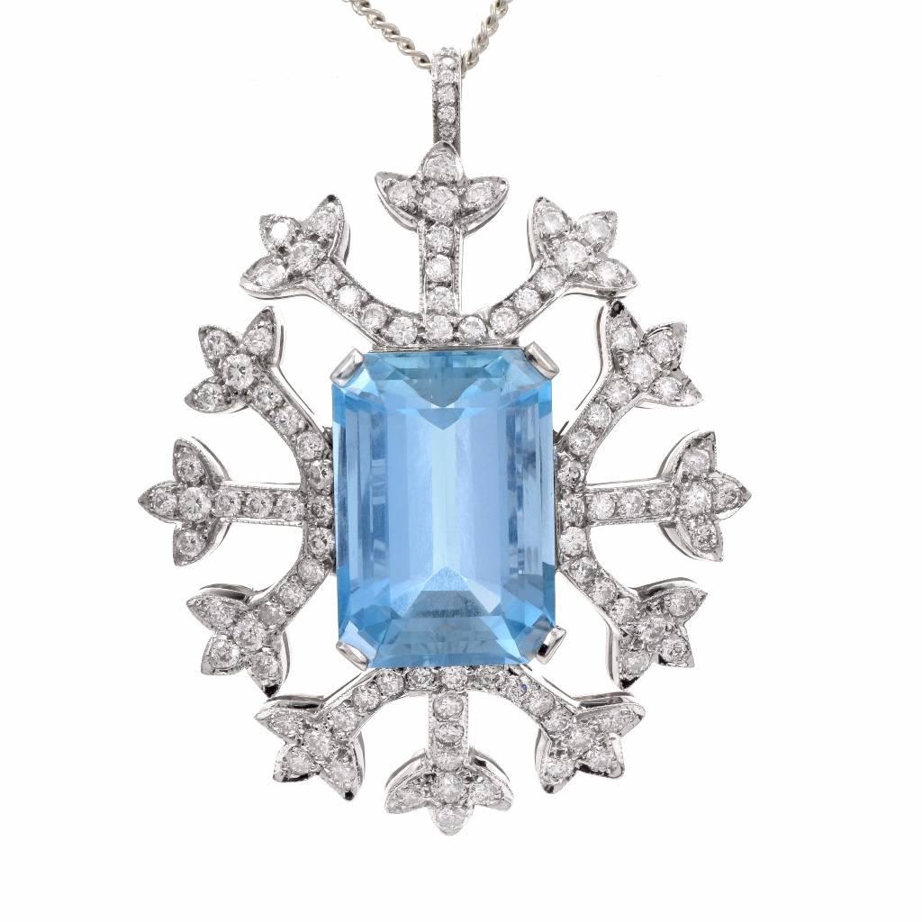 This shimmering Estate Diamond and Aquamarine snowflake pin brooch and pendant is handcrafted in solid 18k white gold. This brooch displays a fabulous snowflake inspired design centered with 1 genuine emerald cut Blue Aquamarine approx: 32.51