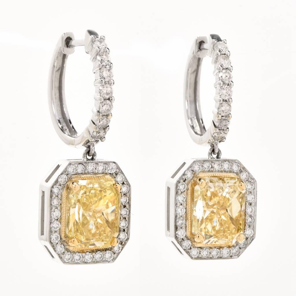This shimmering Natural fancy yellow Diamond earrings are crafted in 14K white gold with yellow gold details. They are centered with 2 genuine Radient cut fancy yellow Diamonds approx: 6.63 carats in total , Natural Fancy Yellow,  VS2 clarity, prong