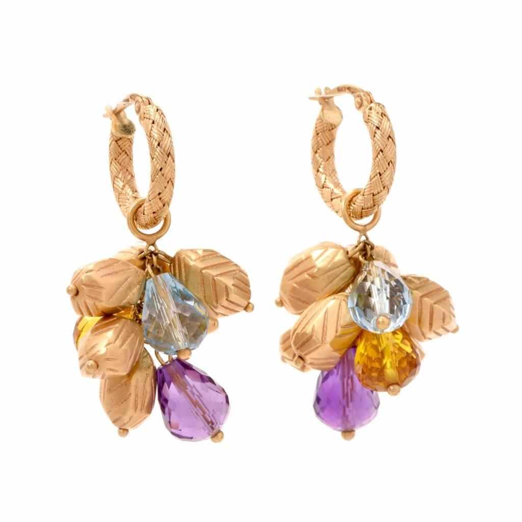 These lovely earrings crafted in 18 karat textured and etched yellow gold are designed to simulate cluster of grapes, attached to detachable hoops to offer versatility of being worn as simple yellow gold hoops or as pendant drop earrings. The grape