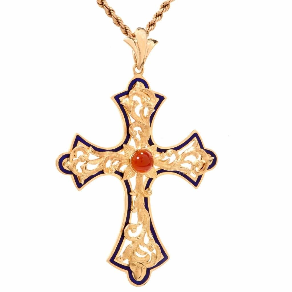 This handmade cross pendant is designed with all details of an orthodox cross, embellished in artistic floral motif relief technique. It is crafted in solid 18- karat yellow gold and exposes at the center a 1.30-carat cabochon carnelian.