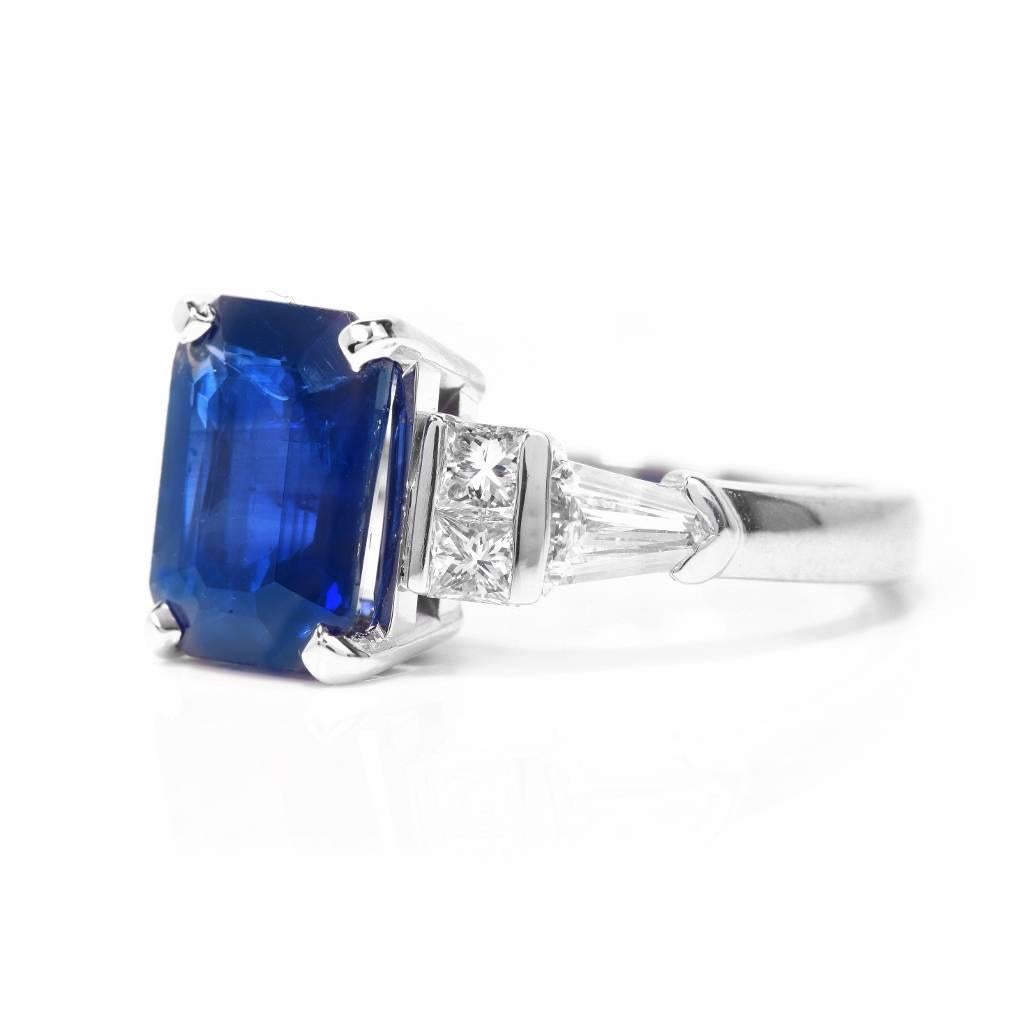 This beautiful Dussi diamond sapphire ring is crafted in platinum. It exposes an emerald-cut natural corundum of an enchanting blue color, of Ceylon provenance. The eye-catching sapphire weighing approx.  4.14 carats with GIA lab report to be