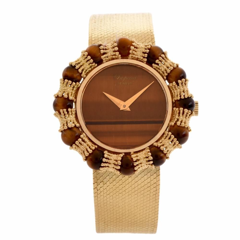 This stylish retro vintage Chopard  timepiece watch is made in 18-karat yellow gold. All original with Chopard  mechanical movement with Tiger's eye dial and toger's eye bezel. 
Bracelet dial movement and case signed Chopard .
More info:
Brand: