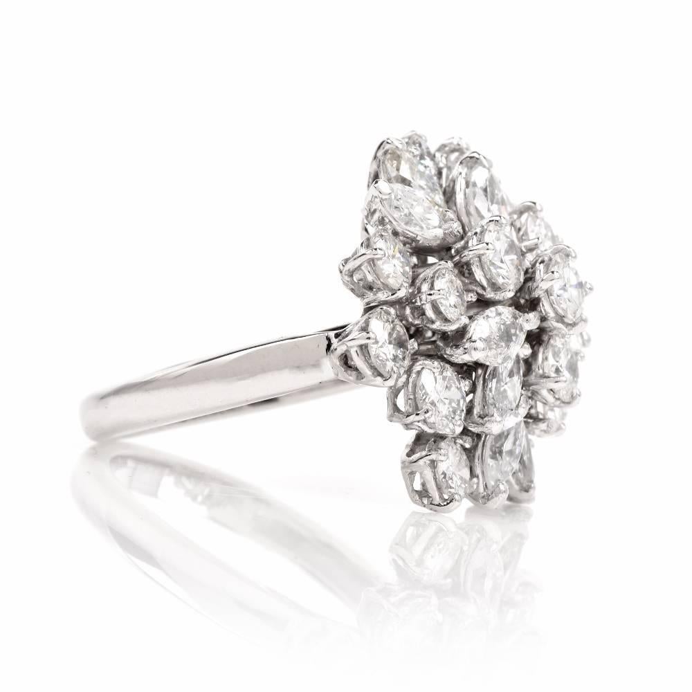 This estate diamond cluster cocktail ring of captivating aesthetic allure and feminine grace is crafted in solid platinum, weighing 9.3 grams and measuring 21 mm wide, 10mm high. Designed as a gracefully pyramidal plaque, assembling 11 high quality
