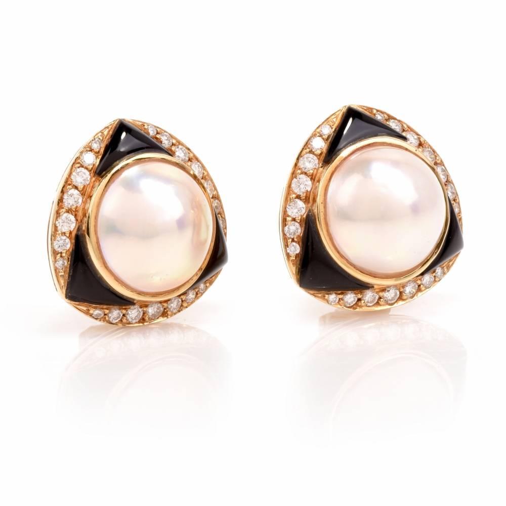 These captivating estate earrings designed and signed by 'Elan' Jewelers are crafted in 18-karat yellow gold, weighing 21.7 grams and measuring 22mm wide and 13 mm deep. Inspired by the opulent Retro earrings, they expose each at the center a