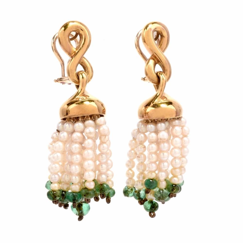 These estate earrings inspired by earlier Oriental designs are crafted in solid 18-karat yellow gold and comprise each with15 tassels of delicate seed pearls with genuine emerald bead at the end. The tassels are strung with 6-8 seed pearls each and
