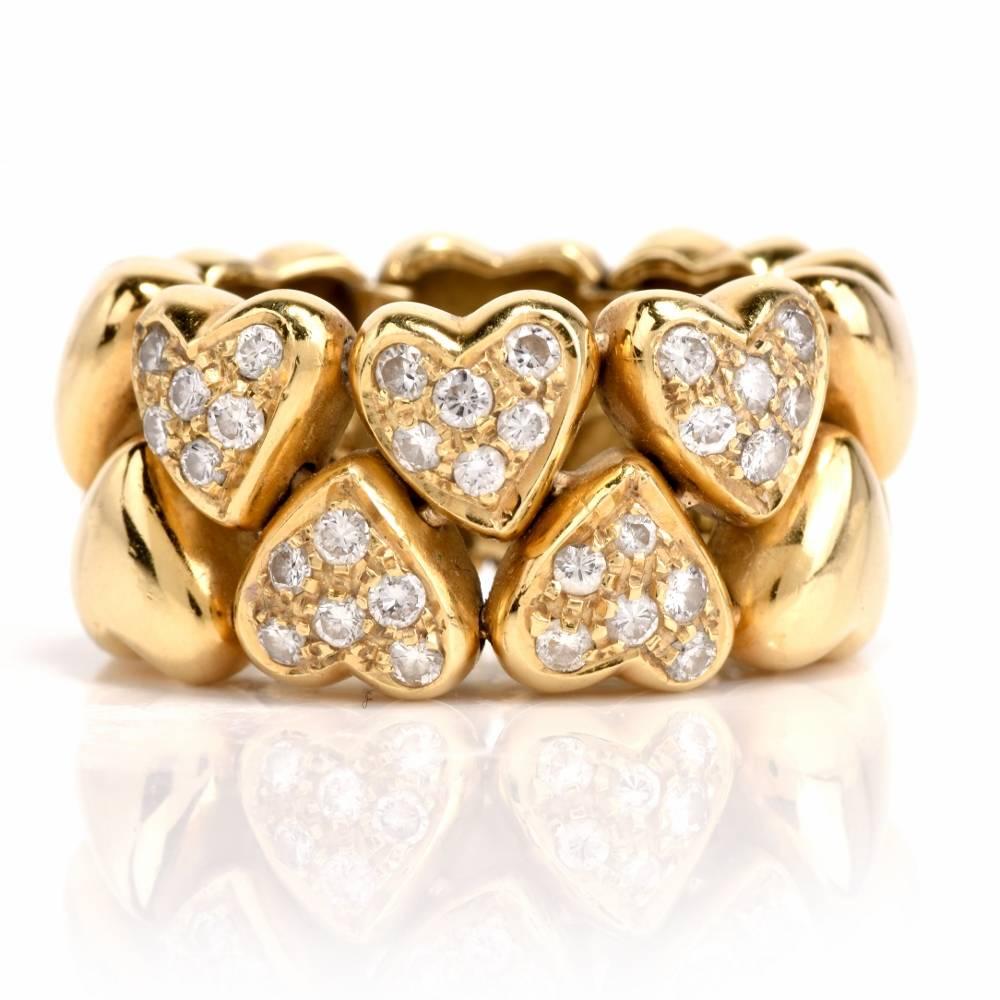 This romantically inspired wide band ring is crafted in solid 18-karat yellow gold and incorporates an assemblage of sculptured heart motif profiles five of which are adorned each with 6 round-facetd diamonds. The 30 pave-set diamonds weigh 0.50