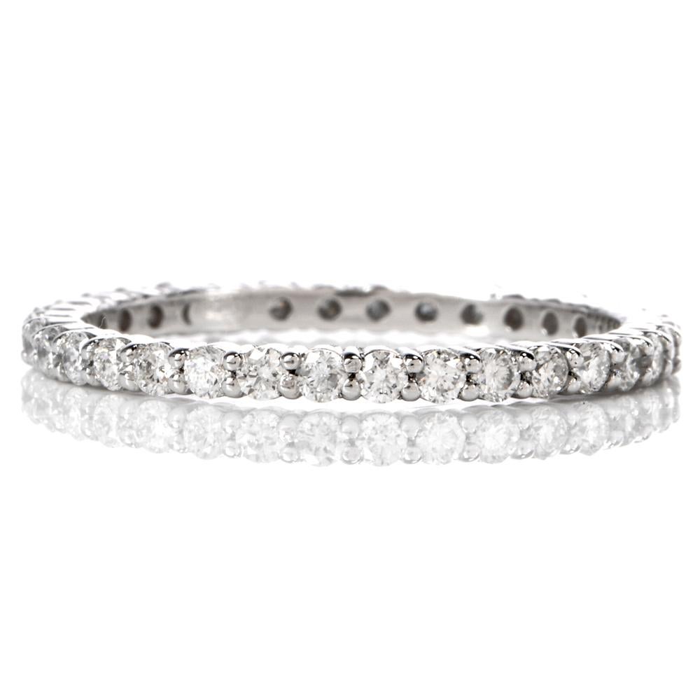 This refined eternity band ring is notable feminine grace is crafted in platinum, weighing 2.2 grams and measuring 1.5mm wide. It is swathed in 0.66 carats of prong-set round faceted - diamonds graded H-I color and VS clarity. This estate eternity
