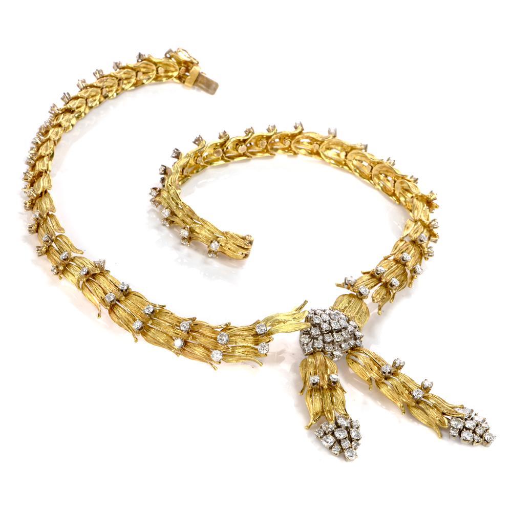 This extravagant diamond choker necklace is crafted in 18-karat yellow gold. Showcasing a botanical pattern of leaf like bunches rendered in textured gold. Prong-set with 132 round-cut diamonds collectively weighing approx. 12.34 carats, graded H-I