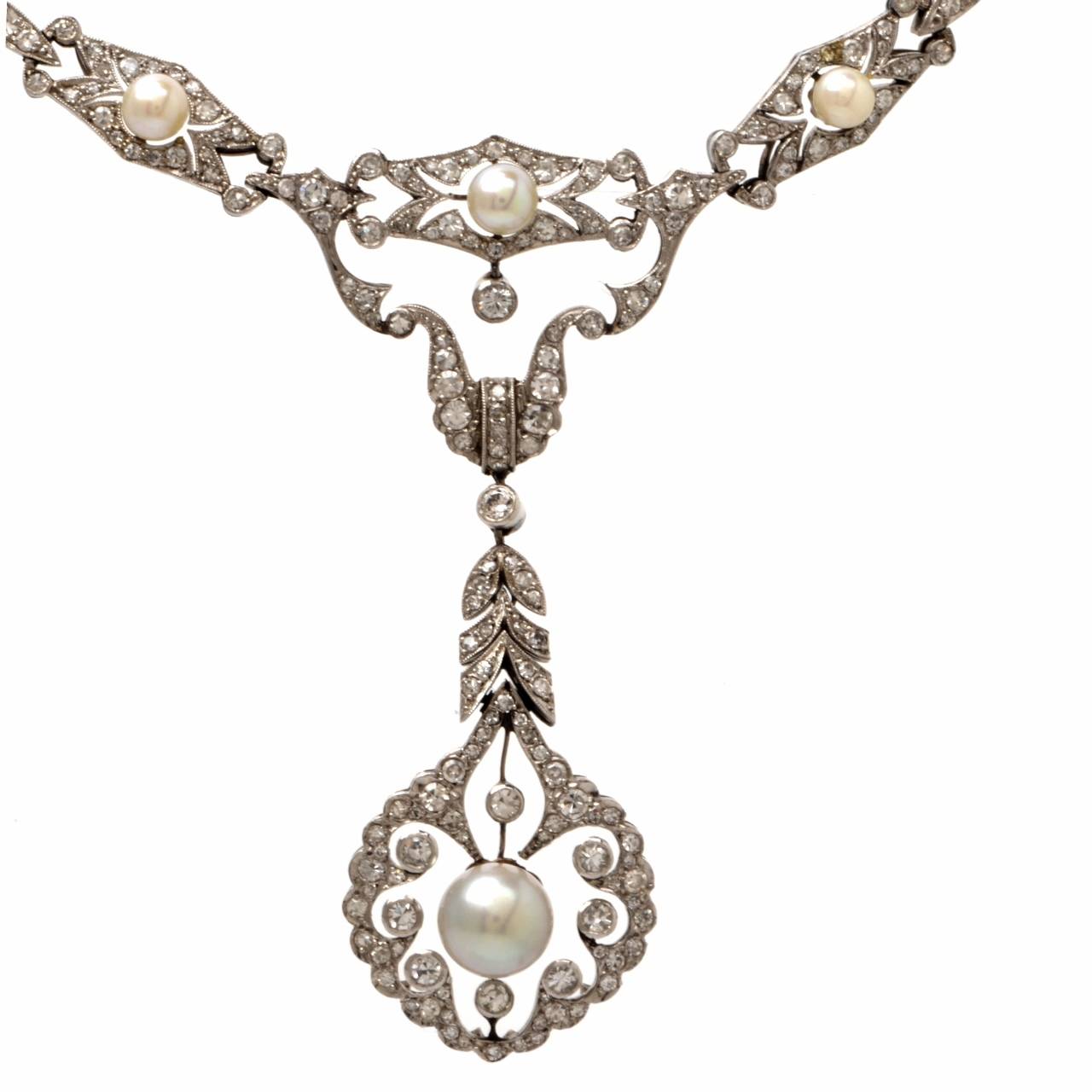 This Breathtaking  Edwardian  diamond pearl necklace of exquisite garland  design and  artistic craftsmanship , is of European provenance,  constructed in solid platinum, weighing 29.4 grams and measuring 17 1/2
