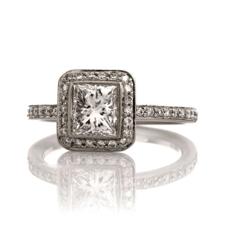 This Ritani engagement ring is crafted in solid platinum. The engagement ring weighs approx. 4.3 grams and features a geometrically inspired rectangular plaque centered with a glittering GIA graded rectangular modified brilliant diamond weighing