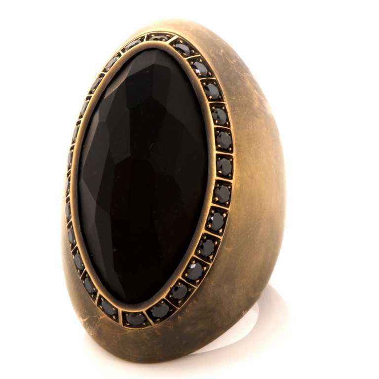 This Preziosismi ring is luxurious and chic, it is crafted in solid 18K blackened gold, weighing approx. 43.9 grams and measuring approx. 41mm x 26mm. This designer ring  is centered with a genuine, sizable faceted obsidian stone (naturally